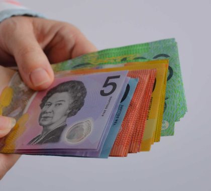 Hands holding Australian currency | Featured image for Managing Cashflow and Why It’s Important for Small Business blog by Go Figured Bookkeeping.